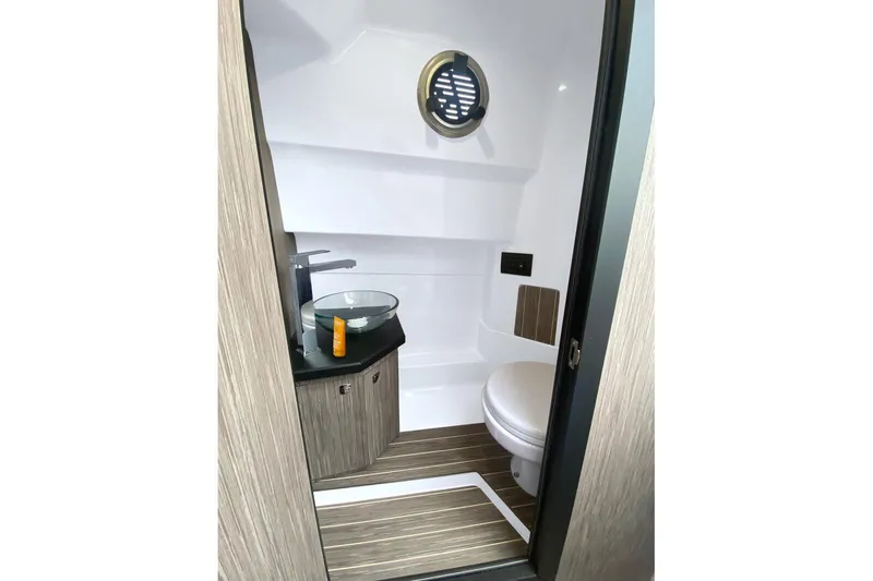 Slide: The Image of 2026 Ranieri CAYMAN 28.0 EXECUTIVE boat bathroom with modern fixtures and wood accents. - 4