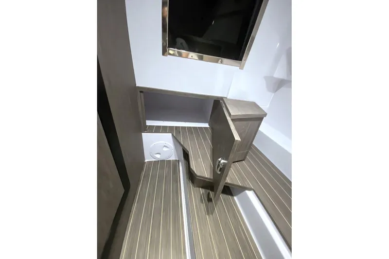 Slide: The Image of Interior of 2026 Ranieri CAYMAN 28.0 EXECUTIVE boat with wooden flooring and storage compartment. - 5