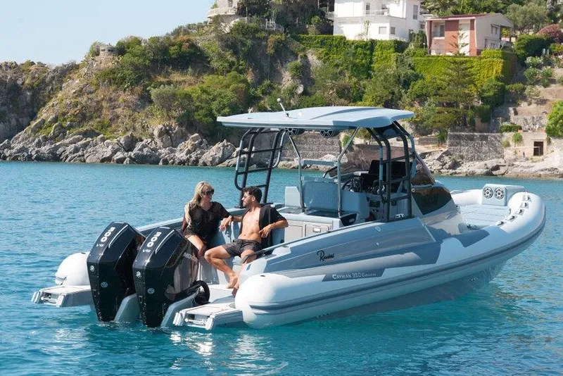 Slide: The Image of 2026 Ranieri CAYMAN 33.0 EXECUTIVE boat on turquoise water near rocky coastline. - 38