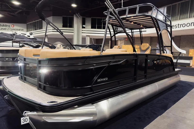 The Image of 2026 Godfrey Monaco 255 Sun Deck pontoon boat displayed indoors. - 0