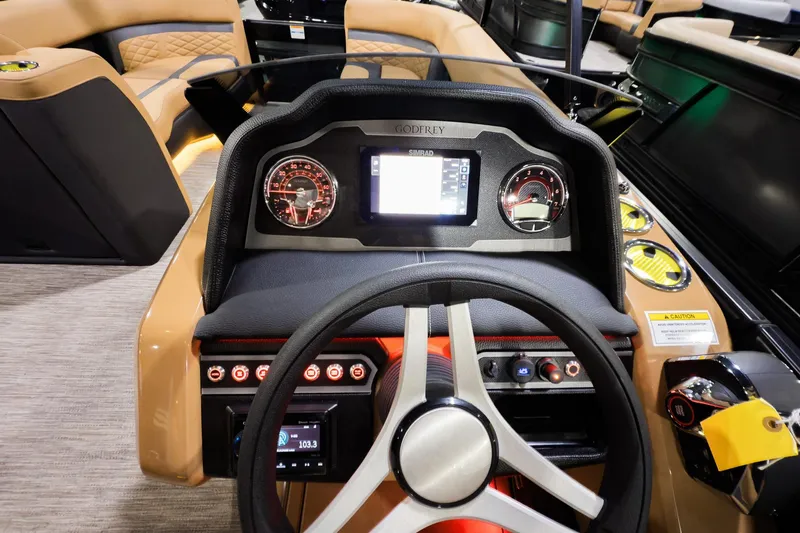 Slide: The Image of 2026 Godfrey Monaco 255 Sun Deck dashboard with modern controls and steering wheel. - 14