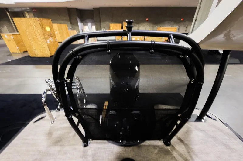 Slide: The Image of 2026 Godfrey Monaco 255 Sun Deck boat interior with protective railing and engine view. - 26