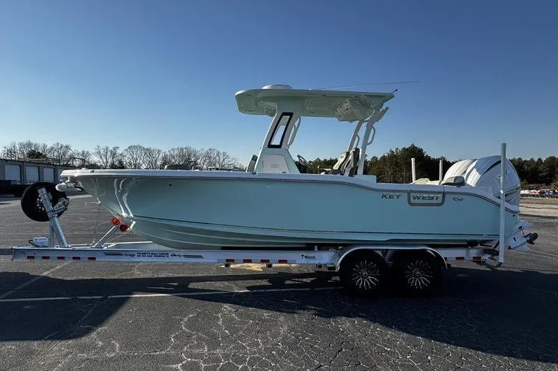 Slide: The Image of 2026 Key West 263 FS boat with twin 300 HP outboard engines in showroom. - 13