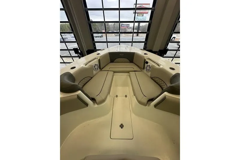 Slide: The Image of 2026 Key West 263 FS boat interior with seating and Garmin equipment in showroom. - 18