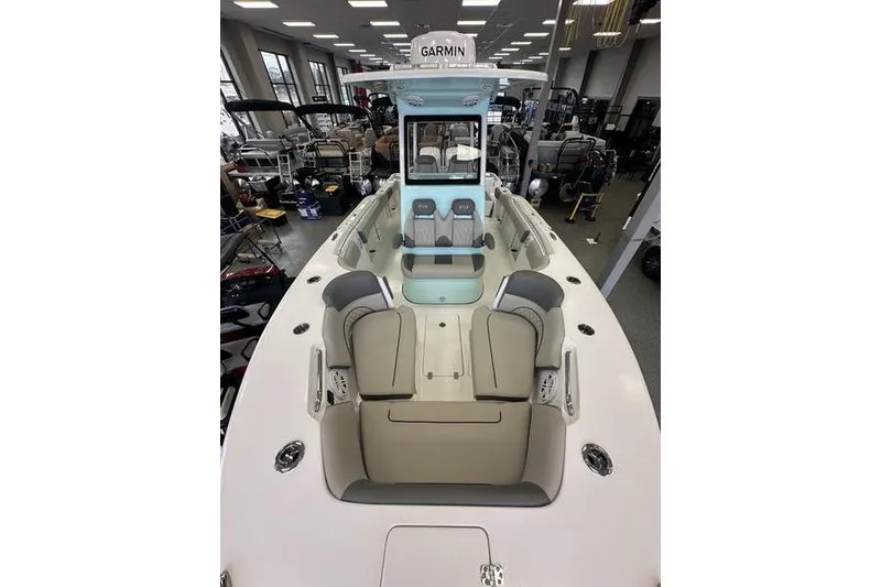 Slide: The Image of 2026 Key West 263 FS boat interior with seating and dual engines in showroom. - 19