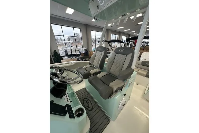 Slide: The Image of 2026 Key West 263 FS boat interior with open livewell and KM logo. - 23