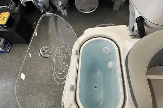 Slide: The Image of 2026 Key West 263 FS boat interior with modern helm and seating in showroom. - 25