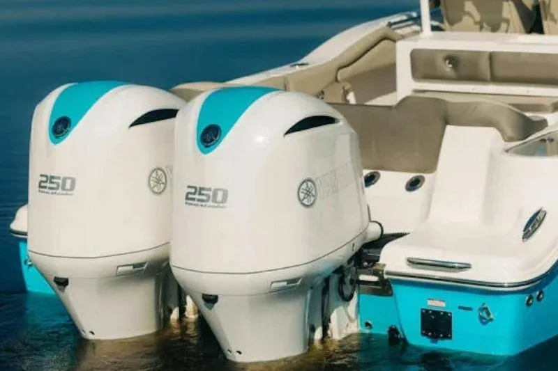 Slide: The Image of 2026 Key West 263 FS boat with twin 250 horsepower engines on calm water. - 27