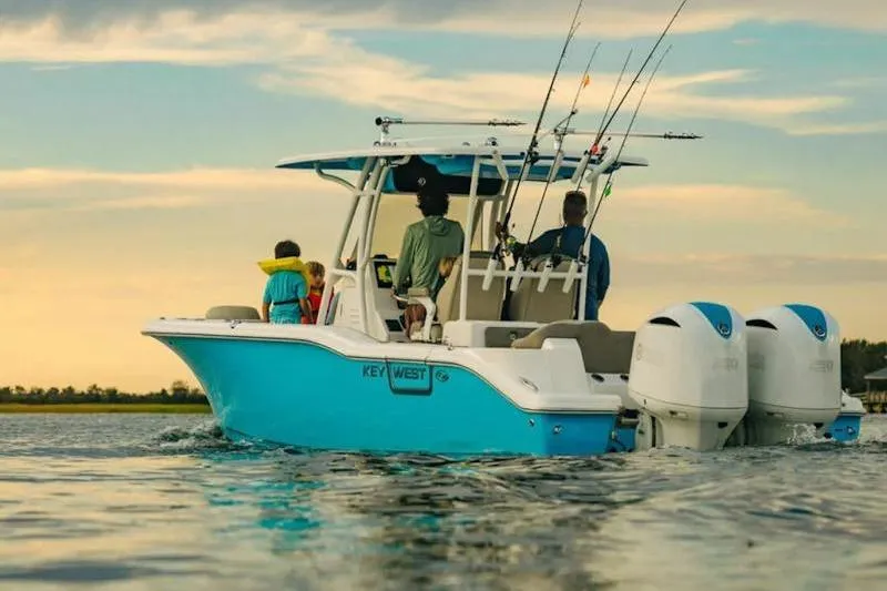 Slide: The Image of 2026 Key West 263 FS boat on water at sunset with passengers and fishing rods. - 28