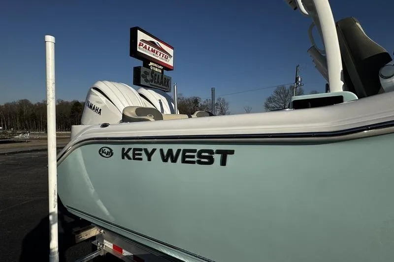Slide: The Image of 2026 Key West 263 FS boat dashboard with navigation screens and steering wheel. - 3