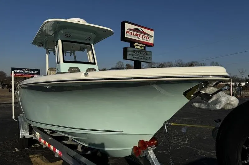Slide: The Image of 2026 Key West 263 FS boat on trailer, parked outdoors near a building. - 5