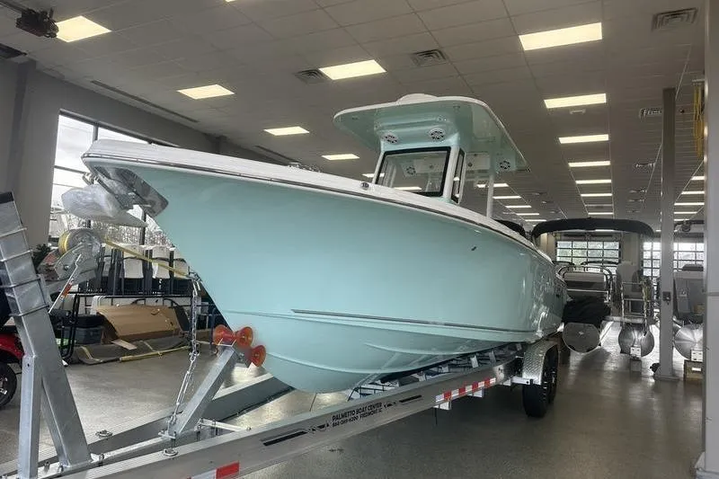 Slide: The Image of 2026 Key West 263 FS boat on trailer in showroom, featuring Yamaha outboard motor. - 8