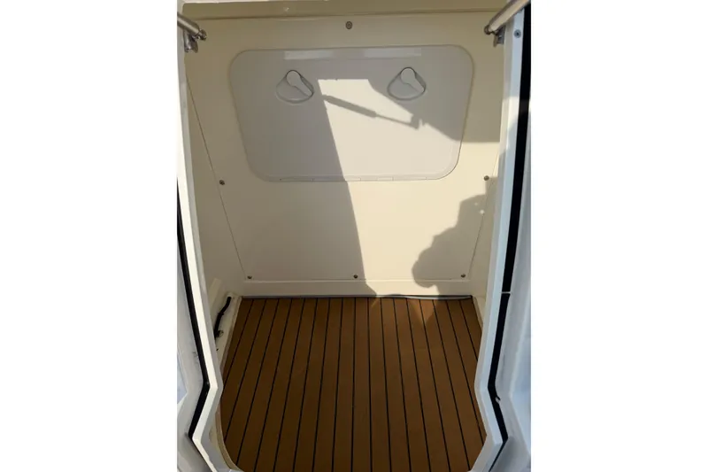 Slide: The Image of 2023 Cobra Ribs Nautique 7.0m interior with wood flooring and storage compartment. - 8