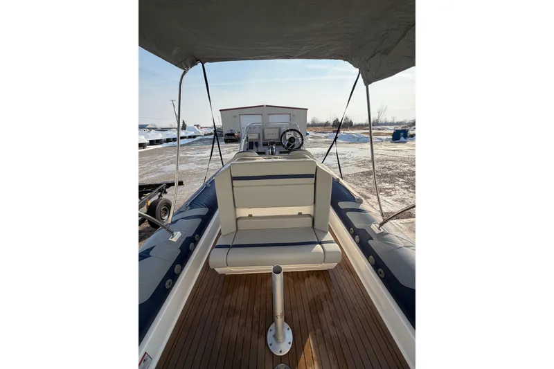 Slide: The Image of 2023 Cobra Ribs Nautique 7.0m boat interior with seating and steering wheel. - 12