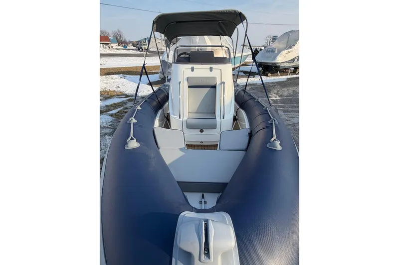 Slide: The Image of 2023 Cobra Ribs Nautique 7.0m inflatable boat with canopy, docked in snowy marina. - 4