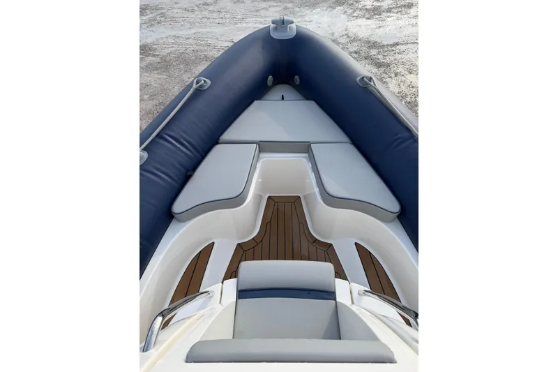 Slide: The Image of 2023 Cobra Ribs Nautique 7.0m boat interior with cushioned seating and wooden flooring. - 6
