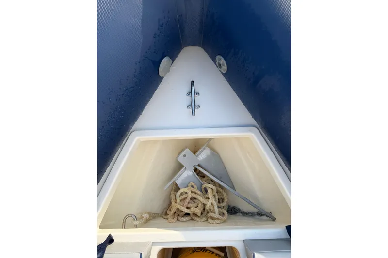 Slide: The Image of Anchor storage compartment on 2023 Cobra Ribs Nautique 7.0m boat, featuring rope and anchor. - 7