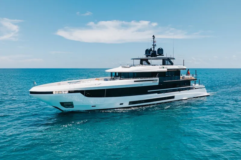 The Image of 2024 Mangusta Oceano 44 yacht cruising on open sea under clear blue sky. - 0