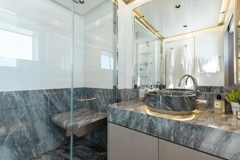 Slide: The Image of Luxurious bathroom in 2024 Mangusta Oceano 44 yacht with marble sink and glass shower. - 43