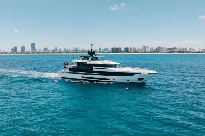 Slide: The Image of 2024 Mangusta Oceano 44 yacht cruising near city skyline on a sunny day. - 7