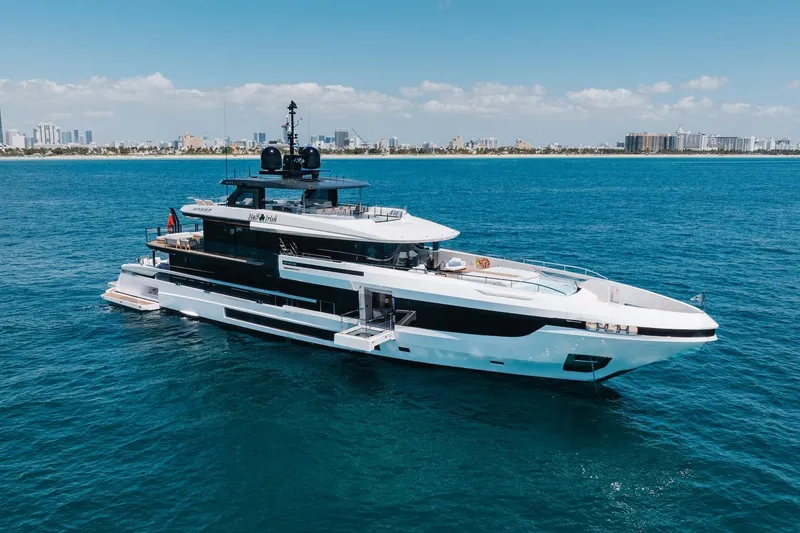 Slide: The Image of 2024 Mangusta Oceano 44 yacht cruising on blue ocean near city skyline. - 8
