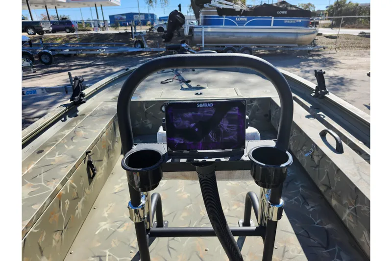 Slide: The Image of 2025 Tracker Grizzly 1654 MVX Sportsman boat interior with Simrad display and cup holders. - 33