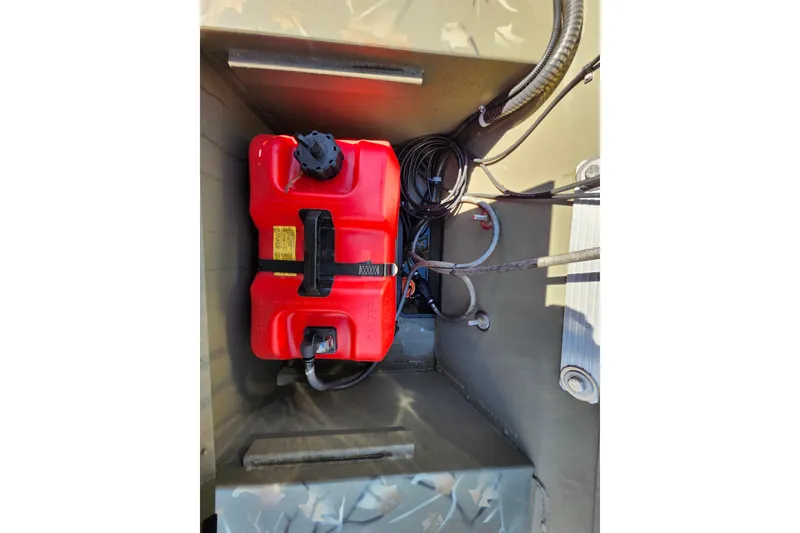 Slide: The Image of Red fuel tank in 2025 Tracker Grizzly 1654 MVX Sportsman boat compartment. - 35