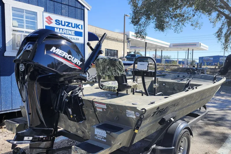 Slide: The Image of 2025 Tracker Grizzly 1654 MVX Sportsman boat with Mercury engine at Suzuki Marine dealer. - 6
