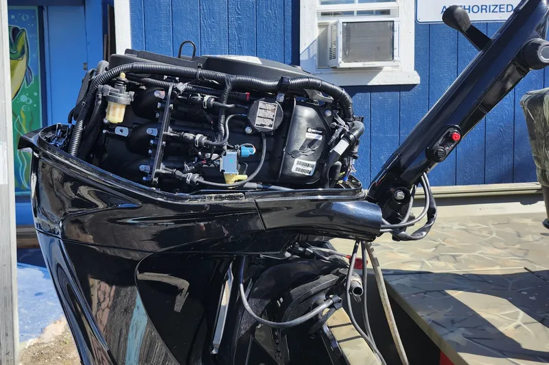 Slide: The Image of 2025 Tracker Grizzly 1654 MVX Sportsman boat engine, detailed view, outdoors. - 8