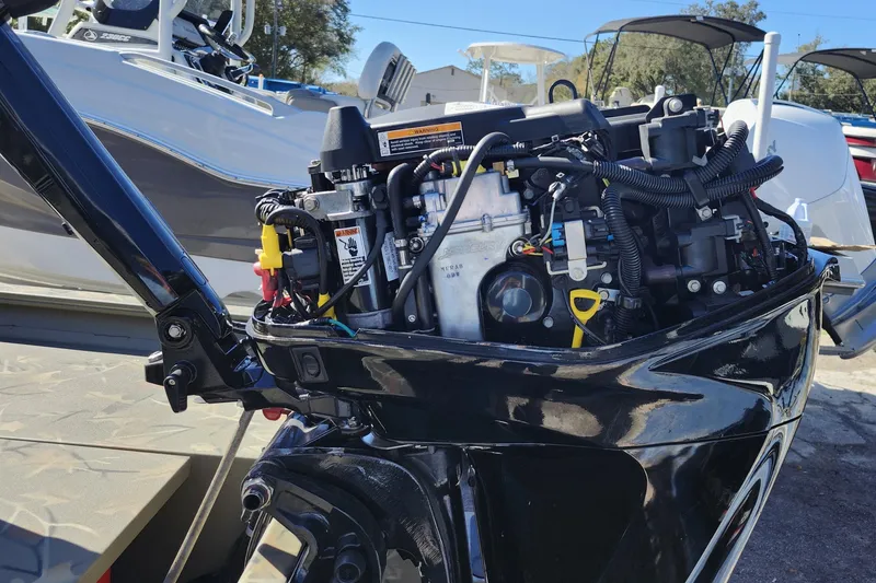 Slide: The Image of 2025 Tracker Grizzly 1654 MVX Sportsman boat engine, detailed view in a marina setting. - 9