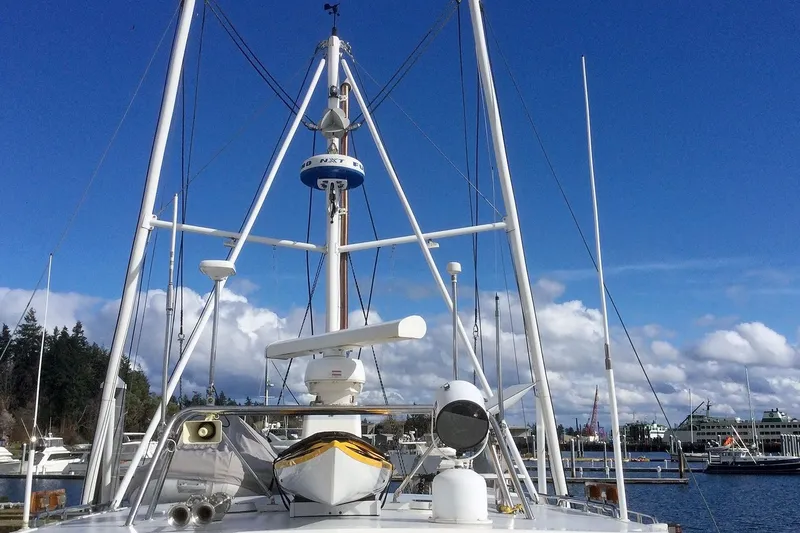Slide: The Image of Nordhavn 46 yacht, 2001 model, docked under clear blue sky with marina background. - 10