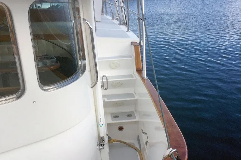 Slide: The Image of Nordhavn 46 yacht deck, 2001 model, with steps and railing by the water. - 11