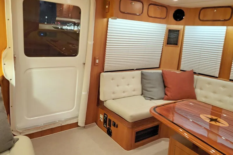 Slide: The Image of Interior of 2001 Nordhavn 46 yacht with cozy seating and wooden table. - 13