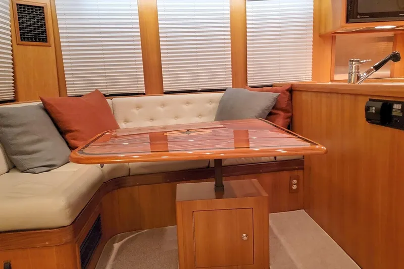 Slide: The Image of Interior of 2001 Nordhavn 46 yacht with cozy seating and wooden table. - 15