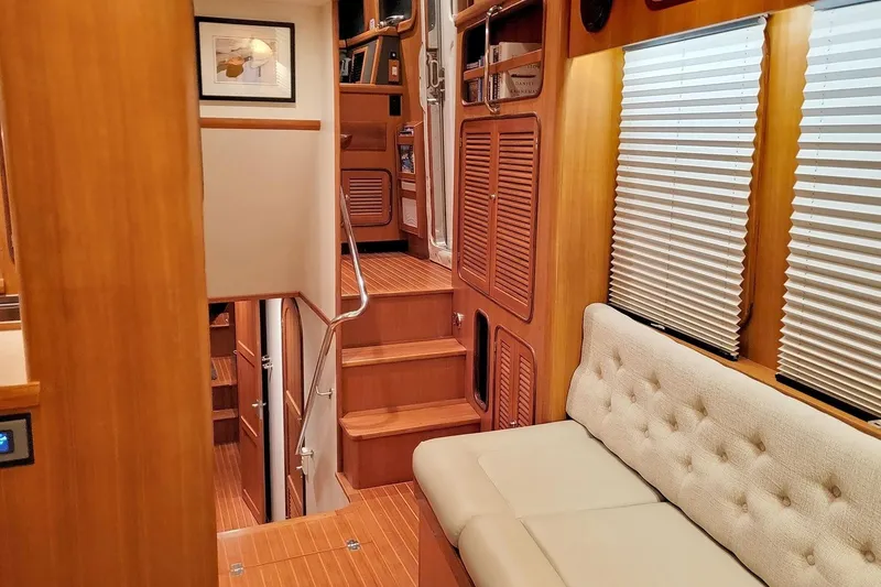 Slide: The Image of Luxurious interior of 2001 Nordhavn 46 yacht with wooden finishes and comfortable seating. - 16