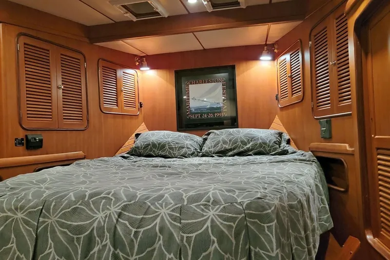 Slide: The Image of Cozy cabin interior of 2001 Nordhavn 46 yacht with wood paneling and double bed. - 27