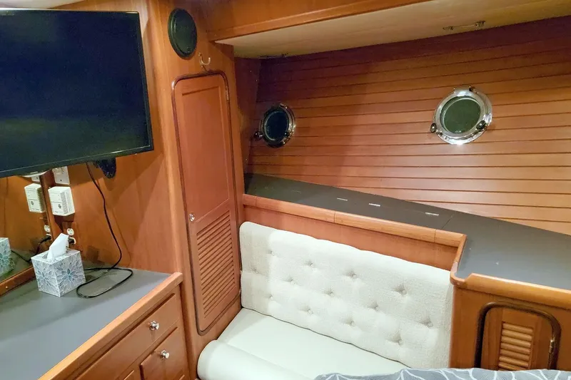 Slide: The Image of Cozy interior of 2001 Nordhavn 46 yacht with wood paneling and portholes. - 30