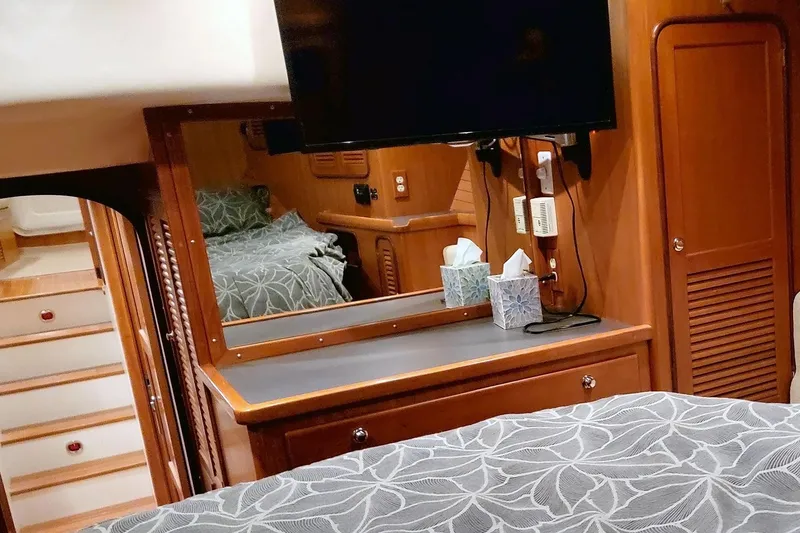 Slide: The Image of Interior of a 2001 Nordhavn 46 yacht, featuring a cozy cabin with wood finishes. - 31