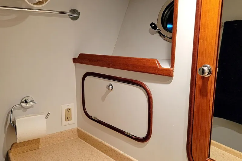 Slide: The Image of Bathroom interior of 2001 Nordhavn 46 yacht with wood accents and porthole. - 32