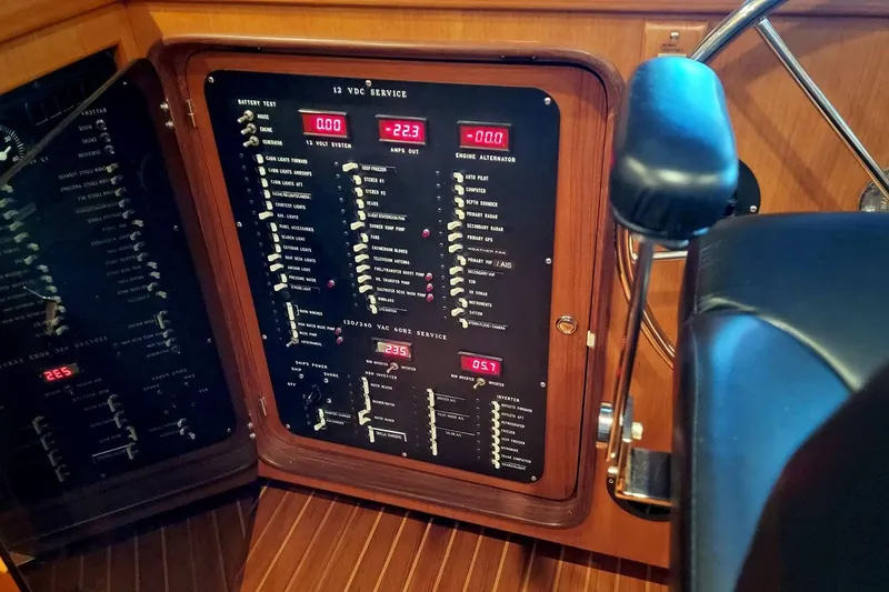 Slide: The Image of Electrical control panel on a 2001 Nordhavn 46 yacht, featuring various switches and displays. - 35