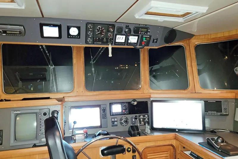 Slide: The Image of Pilothouse of 2001 Nordhavn 46 yacht with navigation equipment and control panels. - 38
