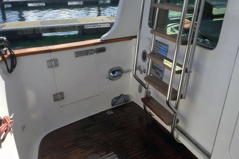 Slide: The Image of Nordhavn 46 yacht deck with wooden steps and stainless steel railings, 2001 model. - 4