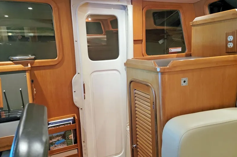 Slide: The Image of Interior of 2001 Nordhavn 46 yacht with wooden cabinetry and white door. - 40