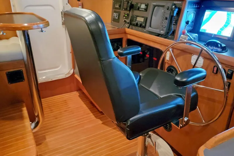 Slide: The Image of Pilot seat and helm of a 2001 Nordhavn 46 yacht, featuring navigation equipment. - 41