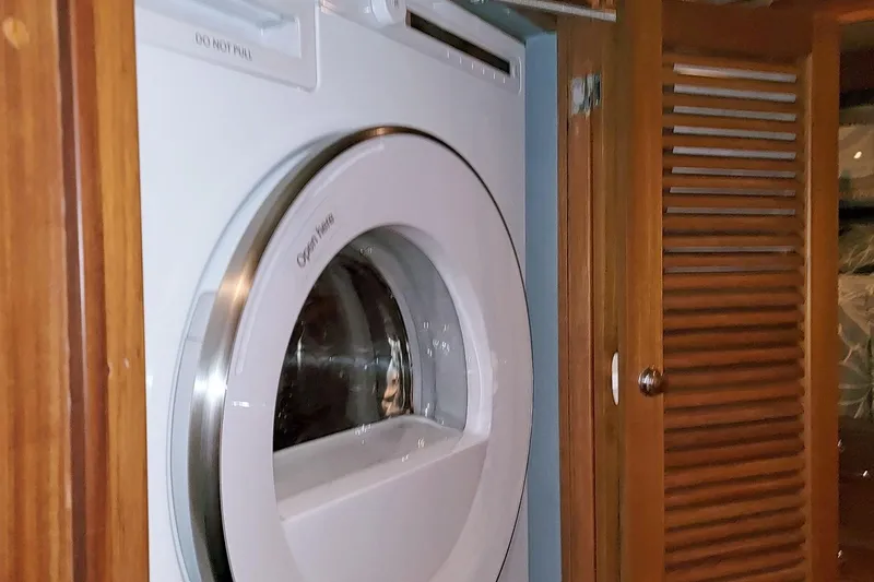 Slide: The Image of Washing machine inside a 2001 Nordhavn 46 yacht's wooden cabinet. - 43