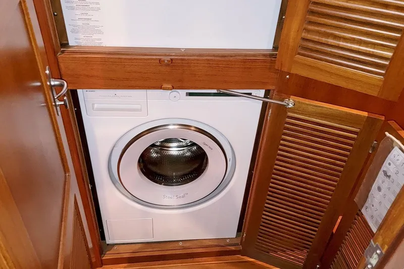 Slide: The Image of Washing machine inside 2001 Nordhavn 46 yacht's wooden cabinet. - 44