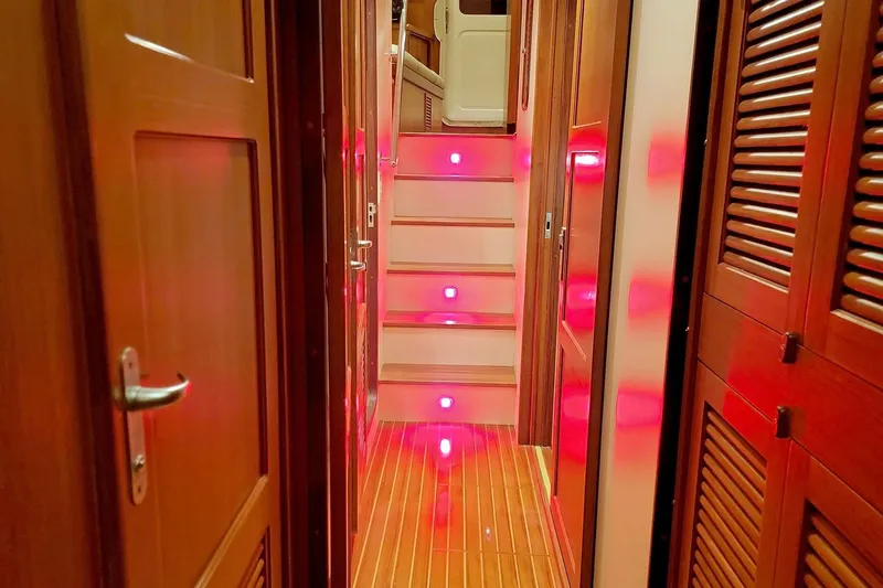 Slide: The Image of Interior of 2001 Nordhavn 46 yacht with illuminated wooden hallway and stairs. - 45