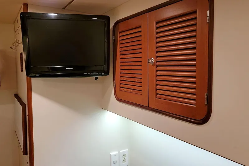 Slide: The Image of Interior of 2001 Nordhavn 46 yacht with TV and wooden cabinet. - 47