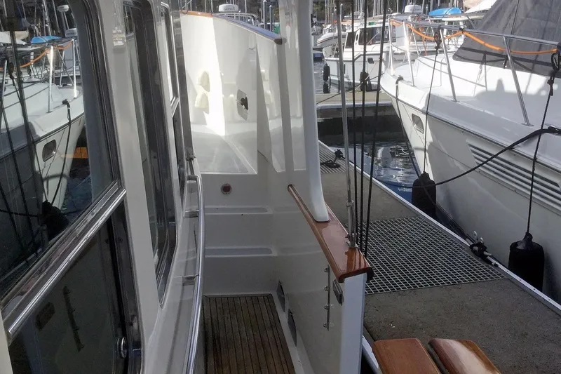 Slide: The Image of Side deck view of 2001 Nordhavn 46 yacht docked at marina. - 5