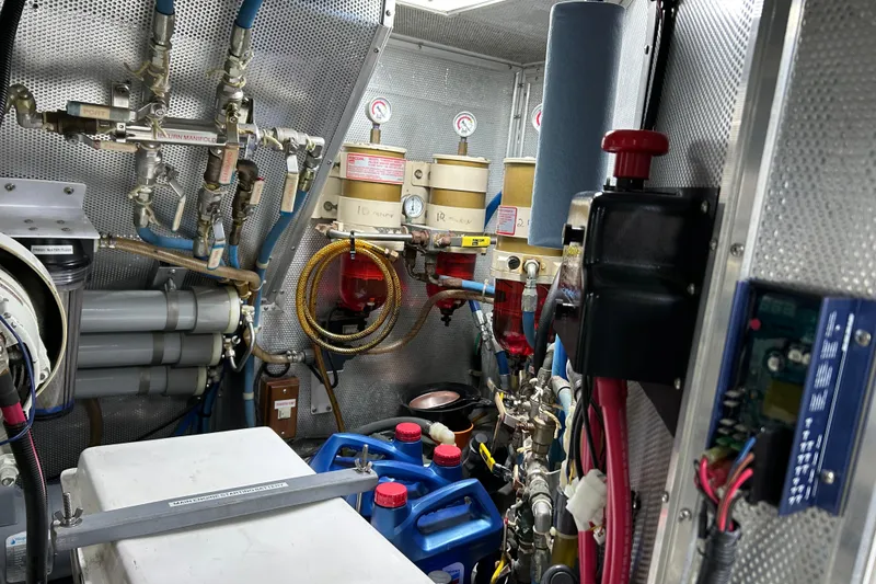 Slide: The Image of Engine room of 2001 Nordhavn 46 yacht, featuring complex piping and control systems. - 51